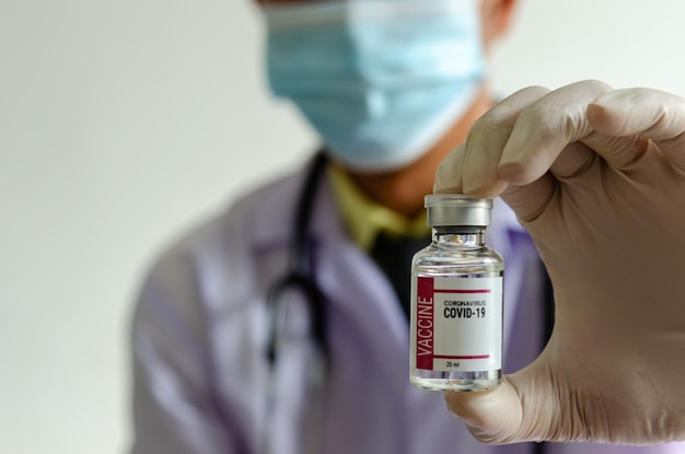 Doctor or scientist holding a bottle of covid vaccine