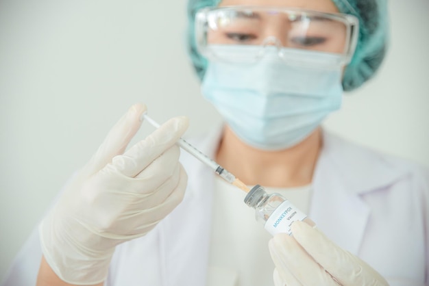 Foto un medico o uno scienziato tiene in mano una fiala di vaccino per il vaiolo delle scimmie o il clade