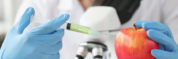 Doctor scientist makes injection into apple in laboratory antibiotic treatment concept