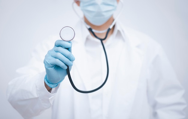 Doctor or scientist with a stethoscope Wearing Medical Mask and Gloves Isolated ,Cheerful mature doctor posing and smiling at camera, healthcare and medicine.