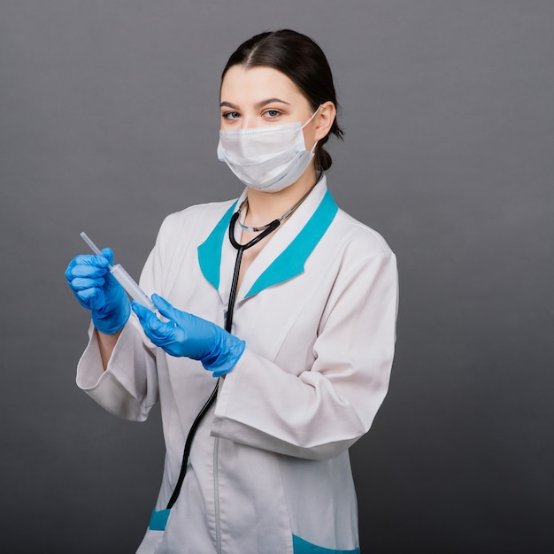 Doctor scientist with syringe analyzing virus Sars-CoV-2 in research for vaccine to be ready for clinical trial.