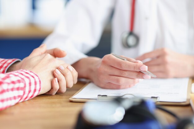 Doctor sees patient and writes down medical indicators on card