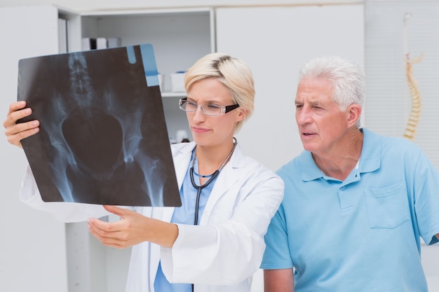 Doctor and senior patient examining x-ray