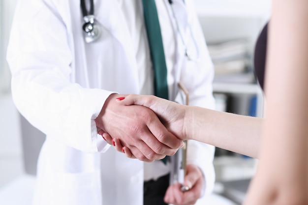 Doctor shake hand as hello with patient in