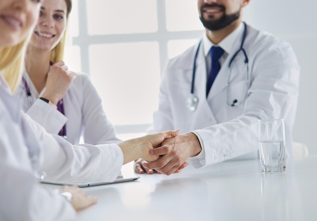 Doctor shaking hands with a male patient in the office