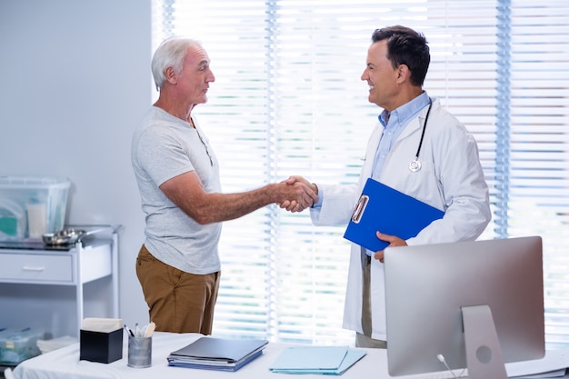 Doctor shaking hands with senior man