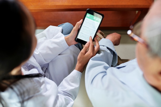 Doctor showing mobile application to patient