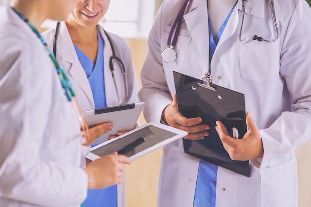 Doctor showing something in his tablet to his medical team