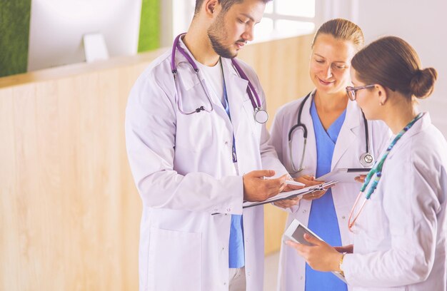 Doctor showing something in his tablet to his medical team