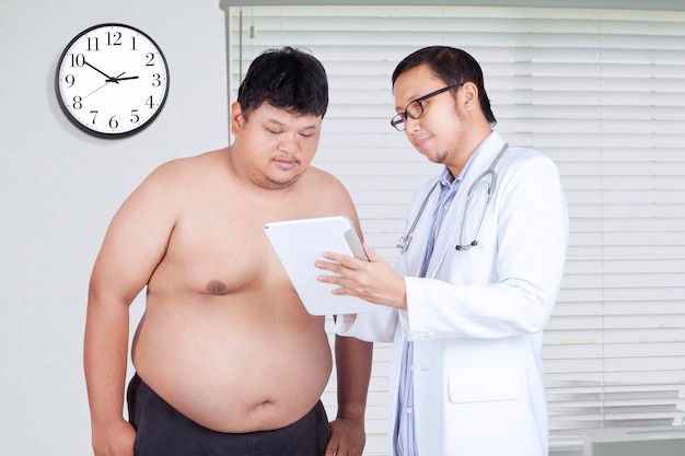 Doctor showing the test result to fat man