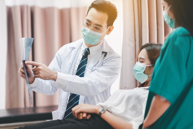 Doctor showing X-ray film results to woman patient,Infertility counseling and suggestion using new technology