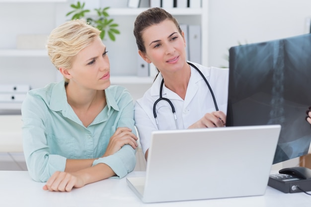 Doctor showing X rays to her patient 