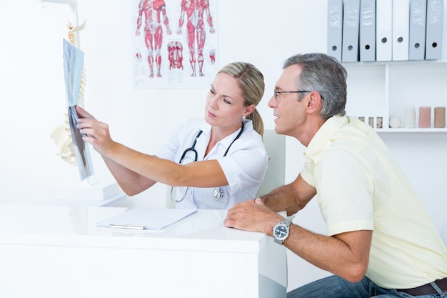 Doctor showing X rays to her patient 