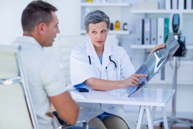 Doctor showing X rays to her patient 