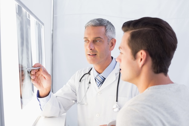 Doctor showing X rays to his patient 