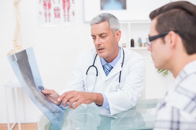 Doctor showing Xrays to his patient 