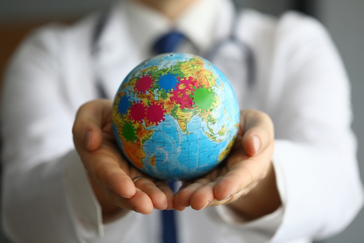 Photo doctor shows globe with coronavirus, world pandemic