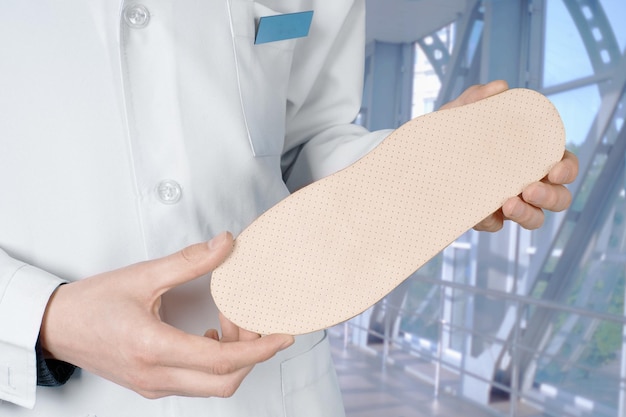 Doctor shows Individual orthopedic insoles