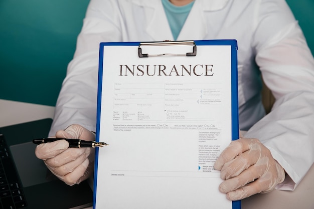 Photo doctor shows insurance contract in his office closeup