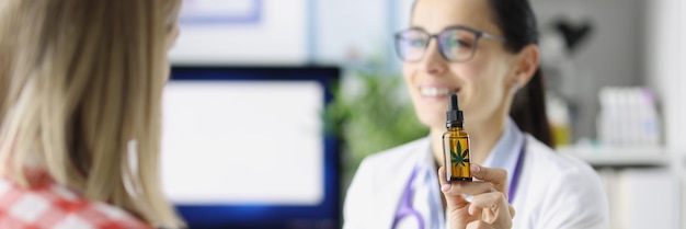 Doctor shows patient bottle of marijuana oil insomnia cure concept