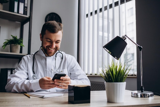 Doctor sitting at table in consulting room