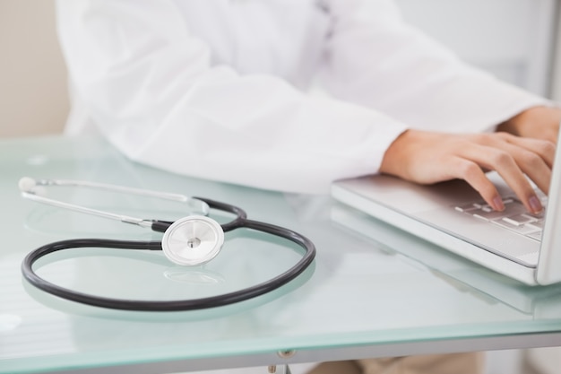 Doctor sitting and using laptop 