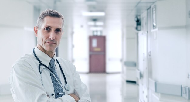 Doctor standing in confident pose, he waiting for help his patient in his office, healthcare and medical concept.