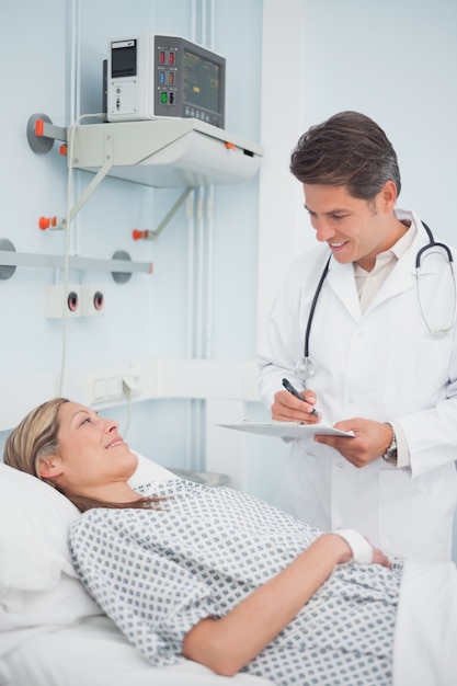 Doctor standing while holding a chart