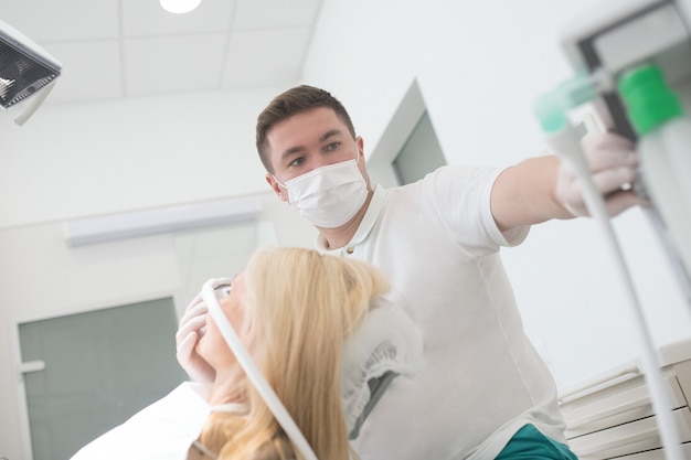 Doctor in a sterile gloves switching on medical equipment