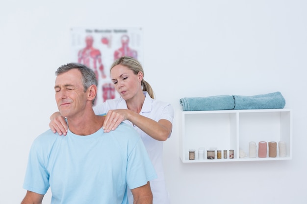 Doctor stretching her patient neck