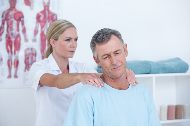 Doctor stretching her patient neck