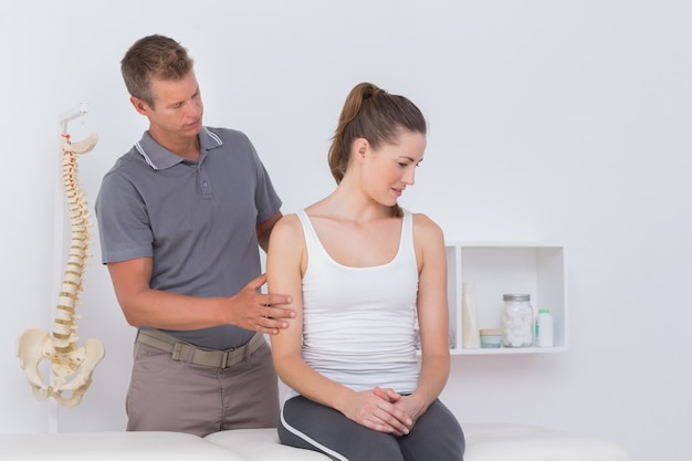 Doctor stretching woman arm