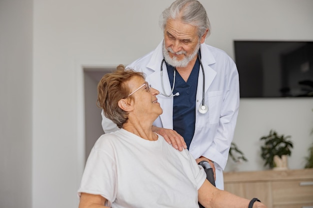 Doctor supporting a sick patient before medical procedures in a hospital room
