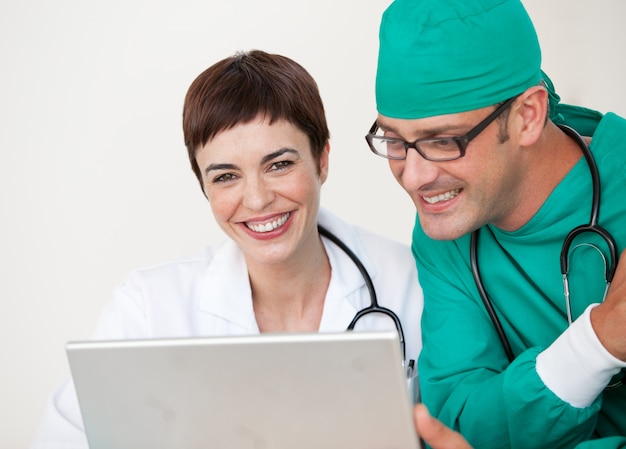 Doctor and surgeon looking at a laptop