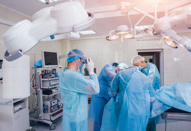 Doctor in a surgical room with virtual reality glasses