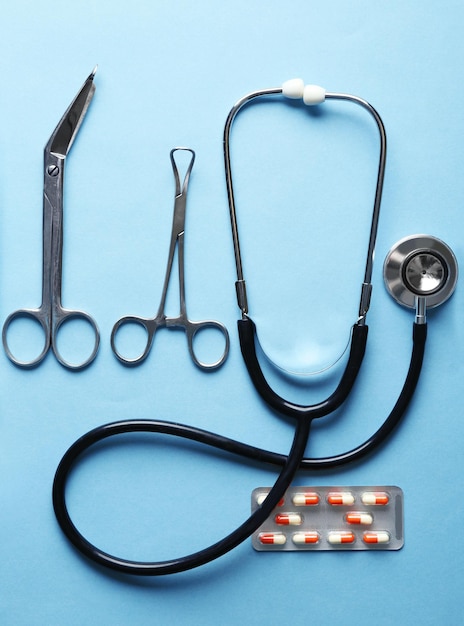 Doctor table with medical items and pills top view