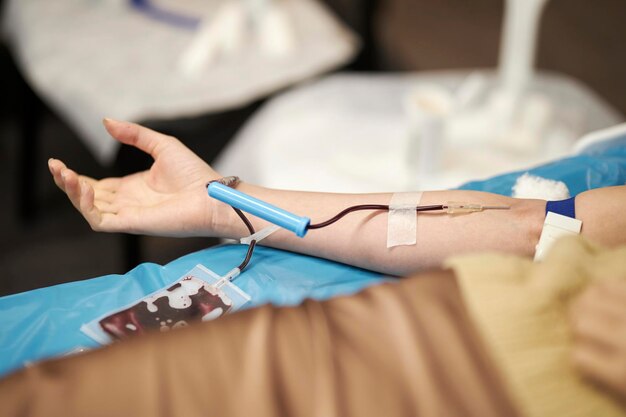 The doctor takes blood from the patient. Blood donation. Donation