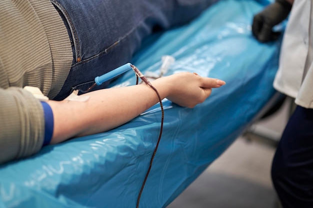 The doctor takes blood from the patient. Blood donation. Donation