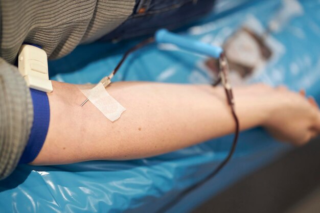 The doctor takes blood from the patient. Blood donation. Donation