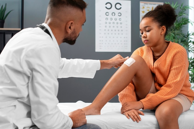 Doctor taking care of afro-american child