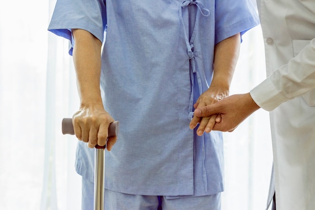 Doctor taking care of suffering senior patient at hospital