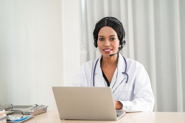 Doctor talking online to a patient suffering from an ache