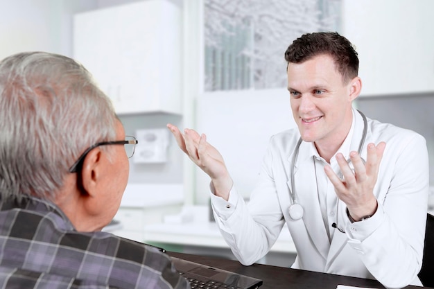 Doctor talking with his patient in the clinic