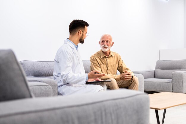 Doctor talking with patient in hospital lobby