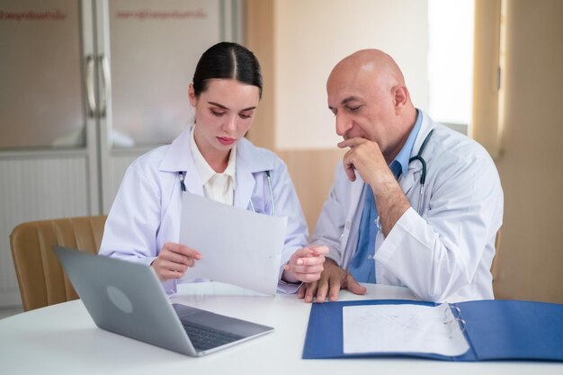 Doctor talking with woman doctor at hospital meeting room