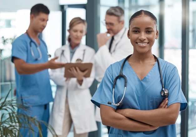 Doctor team and portrait of black woman in the hospital or clinic and smile on face Teamwork collaboration and leadership in healthcare medical care and working in a clinic with nurse and doctors