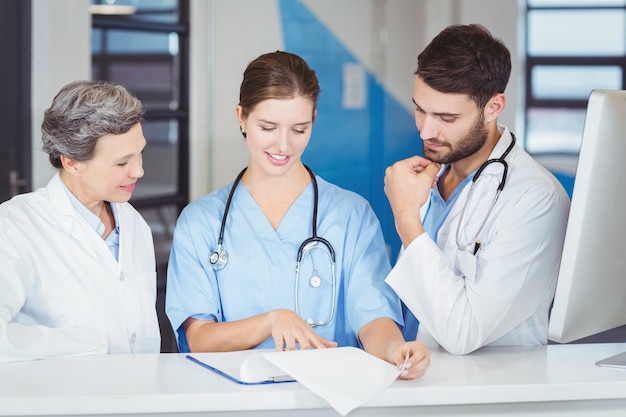 Doctor team working at computer desk 