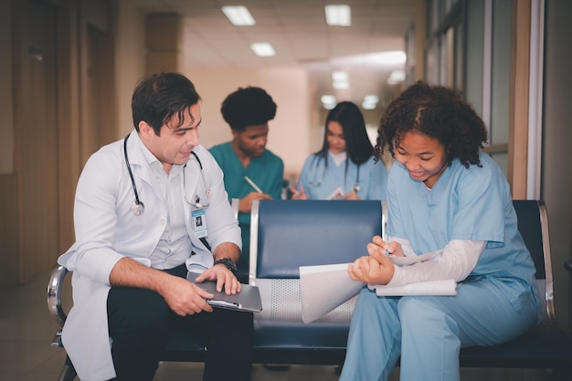 Doctor training nurse student at hospital