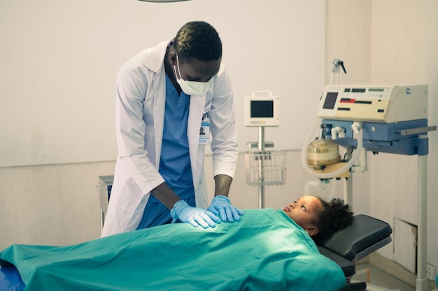 Doctor treating a kid patient in the operating room