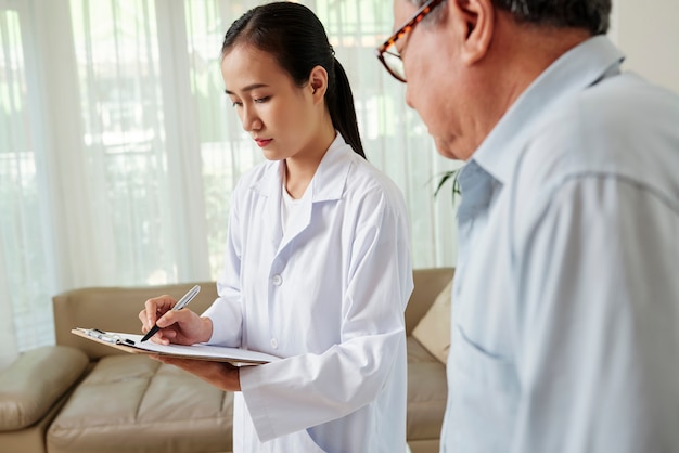 Doctor treating the patient at home